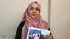 A Uighur in Istanbul, Rozinisa Memet Tohti, holds pictures of family A Uighur in Istanbul, Rozinisa Memet Tohti, holds pictures of family