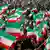 Demonstrators wave Iranian flags in Tehran