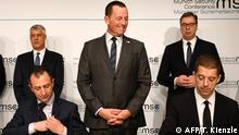 US Ambassador to Germany Richard Grenell (C), the Presidents of Kosovo Hashim Thaci (L background) and Serbia Aleksandar Vucic (R background) watch the signing of an agreement between Kosovo and Serbia for railway and street projects at the Munich Security Conference (MSC) in Munich, southern Germany, on February 14, 2020. - The 2020 edition of the Munich Security Conference (MSC) takes place from February 14 to 16, 2020. (Photo by THOMAS KIENZLE / AFP)