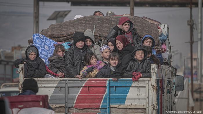 Syrian families are seen on a truck with their belongings on their way to safer zones in Idlib, Syria on February 11, 2020