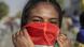 A Sudanese demonstrator holds a flag over her face A Sudanese demonstrator holds a flag over her face