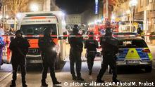 Police stand guard near the scene of a shooting in central Hanau, Germany Thursday, Feb. 20, 2020. German police say several people were shot to death in the city of Hanau on Wednesday evening. (AP Photo/Michael Probst)