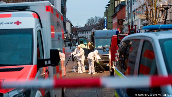Investigators in Hanau look at the street for evidence gathering