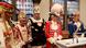 people standing in costume, heads bowed people standing in costume, heads bowed