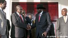 (FILES) In this file photo taken on November 07, 2019 South Sudan's President Salva Kiir (2nd R) and opposition leader Riek Machar (2nd L) shake hands after talks on South Sudan's proposed unity government with Uganda's President Yoweri Museveni (R) and President of Sudan's Transitional Council Abdel Fattah al-Burhan (not in picture) at State House in Entebbe. - South Sudan President Salva Kiir and rebel leader Riek Machar agreed on February 20, 2020, to form a unity government on February 22, 2020, a long-delayed step towards ending six years of war. (Photo by Michael O'HAGAN / AFP)
