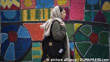 February 17, 2020, Tehran, IRAN: Iranians walk past a mural painting in downtown Tehran, Iran. Many Iranians, battered by economic sanctions, political turmoil and the lingering threat of military conflict, say they are in no mood to vote in the general elections. Speaking of heavy hearts and a sense of bitterness, Tehranis complain that they are tired of politicians who have failed to keep their word or to raise living standards. (Credit Image: Â© Rouzbeh Fouladi/ZUMA Wire |