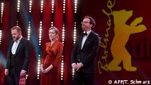 (L-R) German-Bulgarian actor Samuel Finzi, the managing director of the Berlinale film festival Mariette Rissenbeek and Berlinale artistic director Carlo Chatrian observe a minute's silence for the victims of the Hanau killings as they stand on the stage during a ceremony to open the 70th Berlinale international film festival on February 20, 2020 in Berlin. - The 11-day Berlinale, one of Europe's most prestigious film extravaganzas alongside Cannes and Venice, celebrates its 70th anniversary in 2020 and runs until March 1, 2020. At least nine people were killed in two shootings late on February 19, 2020 in Hanau, near the western German city of Frankfurt. (Photo by Tobias SCHWARZ / AFP)