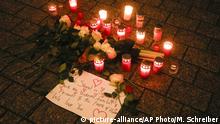 Candles and flowers placed on the floor during a vigil for victims of last night's shooting in the central German town Hanau, at the Brandenburg Gate in Berlin, Germany, Thursday, Feb. 20, 2020. A 43-year-old German man who posted a manifesto calling for the complete extermination of many races or cultures in our midst shot and several people of foreign background on Wednesday night, most of them Turkish, in an attack on a hookah bar and other sites in a Frankfurt suburb, authorities said Thursday. (AP Photo/Markus Schreiber) |