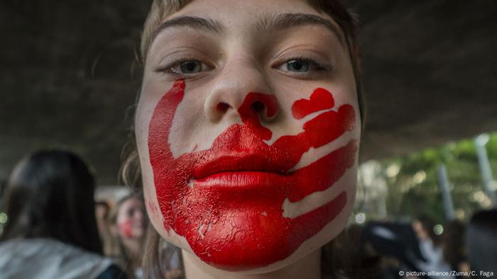 Foto de archivo de una mujer activista con la cara pintada contra la violencia de género.