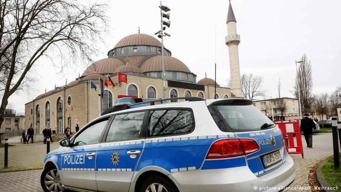 A German police car sits outside a mosque