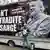 A demonstrator in London stands next to a truck carrying a sign reading, "Don't extradite Assange"