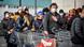 Locals in Italy facing face masks queue outside a supermarket Locals in Italy facing face masks queue outside a supermarket