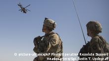 This June 10, 2017 photo released by Operation Resolute Support shows an AH-64 Apache attack helicopter provides security from above while CH-47 Chinooks drop off supplies to U.S. Soldiers with Task Force Iron at Bost Airfield, Afghanistan. Sixteen years into its longest war, the United States is sending another 4,000 troops to Afghanistan in an attempt to turn around a conflict characterized by some of the worst violence since the Taliban were ousted in 2001. They are also facing the emergence of an Islamic State group affiliate and an emboldened Taliban, who by Washington’s own watchdog’s assessment now control nearly half of Afghanistan. (U.S. Marine Corps photo by Sgt. Justin T. Updegraff, Operation Resolute Support via AP) |