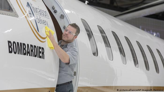 A worker shines up Bombardier's new jetliner, the Global 7500, the longest-range business jet in the world at the company's finishing plant in Montreal