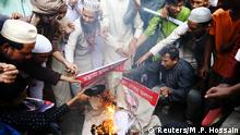 Muslims set fire of a poster of Indian Prime Minister Narendra Modi as they protest the violence against Muslims in India and Modi's scheduled visit to Bangladesh in Dhaka, Bangladesh, February 28, 2020. REUTERS/Mohammad Ponir Hossain