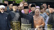 Muhyiddin Yassin, center, waves with his families and supporters as he prepares to leave his house for the palace to swear in as new prime minister, in Kuala Lumpur, Malaysia, Sunday, March 1, 2020. Malaysia's king on Saturday appointed seasoned politician Muhyiddin as the country's new leader, trumping Mahathir Mohamad's bid to return to power after a week of political turmoil that followed his resignation as prime minister. (AP Photo/Johnshen Lee) |