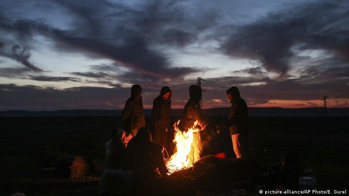 Migrants stand around a bonfire as they try to warm themselves in Edirne, Turkey