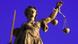 A statue of the Roman goddess of justice, holding a scale A statue of the Roman goddess of justice, holding a scale