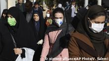 People wearing face masks walk on a sidewalk in downtown Tehran, Iran, Monday, March 2, 2020. A member of a council that advises Iran's supreme leader died Monday after falling sick from the new coronavirus, becoming the first top official to succumb to the illness striking both citizens and leaders of the Islamic Republic. (AP Photo Vahid Salemi) |