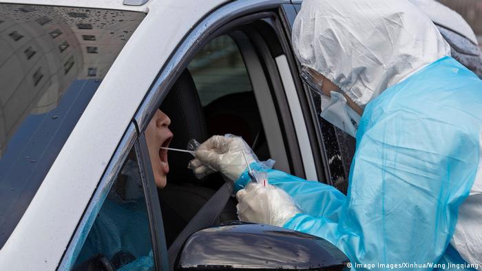 A medical worker of hospital of Yeungnam University makes health screening at a drive-through clinic in Daegu, South Korea, March 4, 2020.