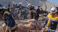 EDITORS NOTE: Graphic content / Members of the Syrian Civil Defence, also known as the White Helmets, recover bodies in the town of Maaret Misrin following Syrian government forces airstrikes on March 5, 2020 in Syria's northwestern Idlib province. - Russian air strikes killed at least 15 civilians including a child in the last major opposition bastion of Idlib in northwestern Syria, a Britain-based war monitor said.
The strikes after midnight targeted an area where displaced Syrians had gathered outside the town of Maaret Misrin in Idlib province, the Syrian Observatory for Human Rights said. (Photo by Ahmad al-ATRASH / AFP) (Photo by AHMAD AL-ATRASH/AFP via Getty Images)