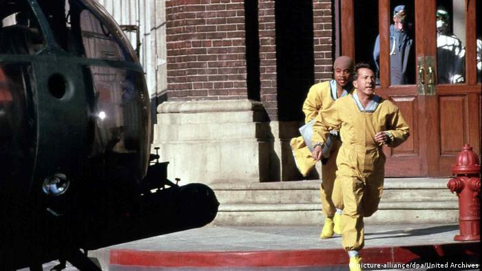 Film still Outbreak two men run away from a out of a building 