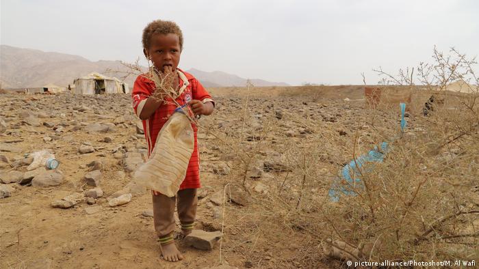 A child plays at a displaced camp in Haradh District of Hajjah province, Yemen,