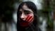 A woman in Lebanon, with a red hand painted on her face, protests against sexual harassment A woman in Lebanon, with a red hand painted on her face, protests against sexual harassment
