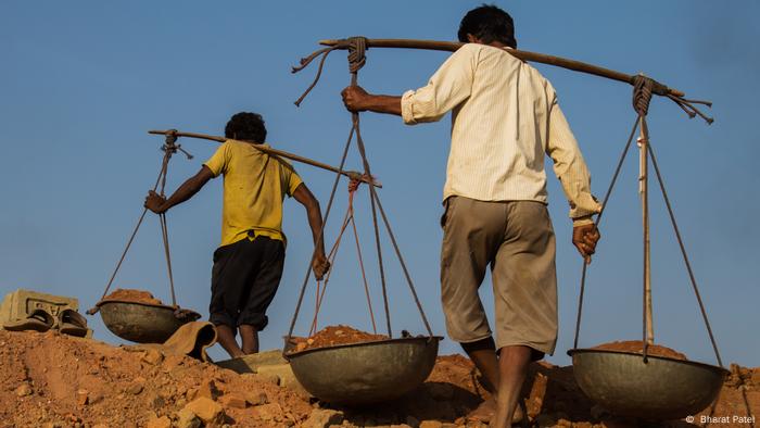 Modern slavery. Men toiling in a mine