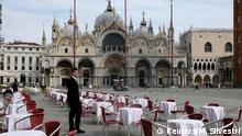 A waiter stands by empty tables outside a restaurant at St Mark's Square after the Italian government imposed a virtual lockdown on the north of Italy including Venice to try to contain a coronavirus outbreak, in Venice, Italy, March 9, 2020. REUTERS/Manuel Silvestri