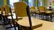 Chairs stacked neatly on top of desks in a classroom in a closed school in Germany. Archive image from March 2020. Chairs stacked neatly on top of desks in a classroom in a closed school in Germany. Archive image from March 2020.
