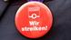 A strike button and a Lufthansa pin A strike button and a Lufthansa pin