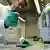 Homem de jaleco branco manipula aparelho com pipetas para realizar testes de uma vacina contra o coronavírus na empresa alemã Curevac.