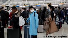 Passengers waiting to check in for an Air China flight are seen with face masks on, after further cases of coronavirus were confirmed in New York, at JFK International Airport in New York, U.S., March 13, 2020. REUTERS/Shannon Stapleton