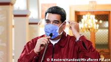 Venezuela's President Nicolas Maduro wears a protective face mask as he speaks during a meeting at Miraflores Palace in Caracas, Venezuela March 13, 2020. Miraflores Palace/Handout via REUTERS ATTENTION EDITORS - THIS PICTURE WAS PROVIDED BY A THIRD PARTY. NO RESALES. NO ARCHIVES.