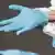 Person putting surgical gloves on