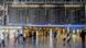 Flight passengers are seen next to a board displaying cancelled flights and departures at the airport of Frankfurt am Main Flight passengers are seen next to a board displaying cancelled flights and departures at the airport of Frankfurt am Main