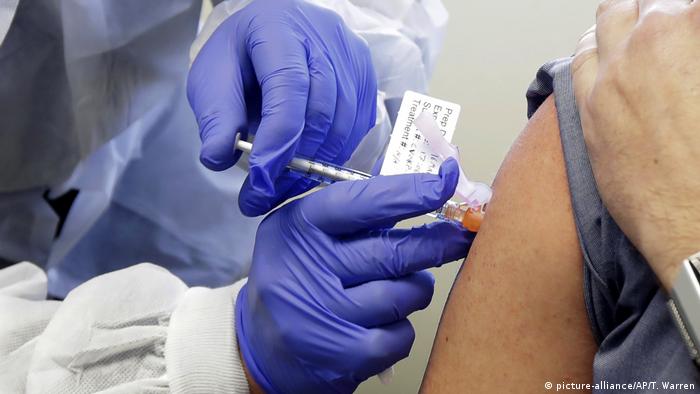 Patient receives a shot in the first-stage safety study clinical trial of a potential vaccine for COVID-19