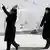 Two Iranian women in black during a funeral from the coronavirus outbreak