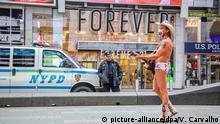 25.03.2020, USA, New York: Der Naked Cowboy, US-amerikanischer Straßenmusiker, trägt einen Mundschutz, als er auf dem Times Square in Manhattan auftritt. Foto: Vanessa Carvalho/ZUMA Wire/dpa +++ dpa-Bildfunk +++ |