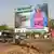 An election campagin board by a busy road in Mali
