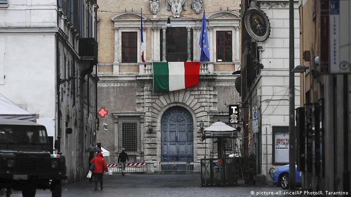 The Italian flag hangs from the balcony of the French Embassy in Rome