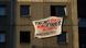 A poster supporting homeless people and refugees is displayed at an apartment building in central Berlin A poster supporting homeless people and refugees is displayed at an apartment building in central Berlin