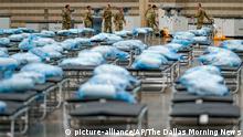 Members of the Texas Army National Guard unpack crates of supplies as they set up a field hospital in response to the new coronavirus pandemic at the Kay Bailey Hutchison Convention Center on Tuesday, March 31, 2020, in Dallas. (Smiley N. Pool/The Dallas Morning News via AP, Pool)