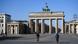 Just a couple of people on the normally packed square in front of Berlin's Brandenburg Gate Just a couple of people on the normally packed square in front of Berlin's Brandenburg Gate