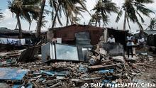 23.03.2019
An owner (2nd R) stays at his destroyed bar after the cyclon Idai hit near the beach in Beira, Mozambique, on March 23, 2019. - The death toll in Mozambique on March 23, 2019 climbed to 417 after a cyclone pummelled swathes of the southern African country, flooding thousands of square kilometres, as the UN stepped up calls for more help for survivors. Cyclone Idai smashed into the coast of central Mozambique last week, unleashing hurricane-force winds and rains that flooded the hinterland and drenched eastern Zimbabwe leaving a trail of destruction. (Photo by Yasuyoshi CHIBA / AFP) (Photo credit should read YASUYOSHI CHIBA/AFP via Getty Images)