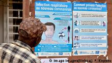  200307 -- YAOUNDE, March 7, 2020 Xinhua -- A man watches posters about COVID-19 in Yaounde, Cameroon, March 6, 2020. Cameroon s Ministry of Public Health confirmed on Friday the country s first and second case of COVID-19. The two patients are now in solitary confinement in Yaounde Central Hospital for treatment. The health authorities are tracing other persons having a higher risk of being contaminated. Photo by Jean Pierre Kepseu/Xinhua CAMEROON-YAOUNDE-COVID-19 PUBLICATIONxNOTxINxCHN