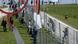 People gather at the closed border between Germany and Switzerland, talking to each other from either side of fences. People gather at the closed border between Germany and Switzerland, talking to each other from either side of fences.