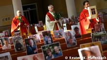 Priest Joachim Giesler holds a mass with photos of believers who were asked to send in pictures after the service was closed due to the spread of coronavirus disease (COVID-19) in Achern, Germany, April 5, 2020. REUTERS/Kai Pfaffenbach TPX IMAGES OF THE DAY
