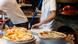 Inside a pizzeria making traditional Neapolitan-style pizza Inside a pizzeria making traditional Neapolitan-style pizza